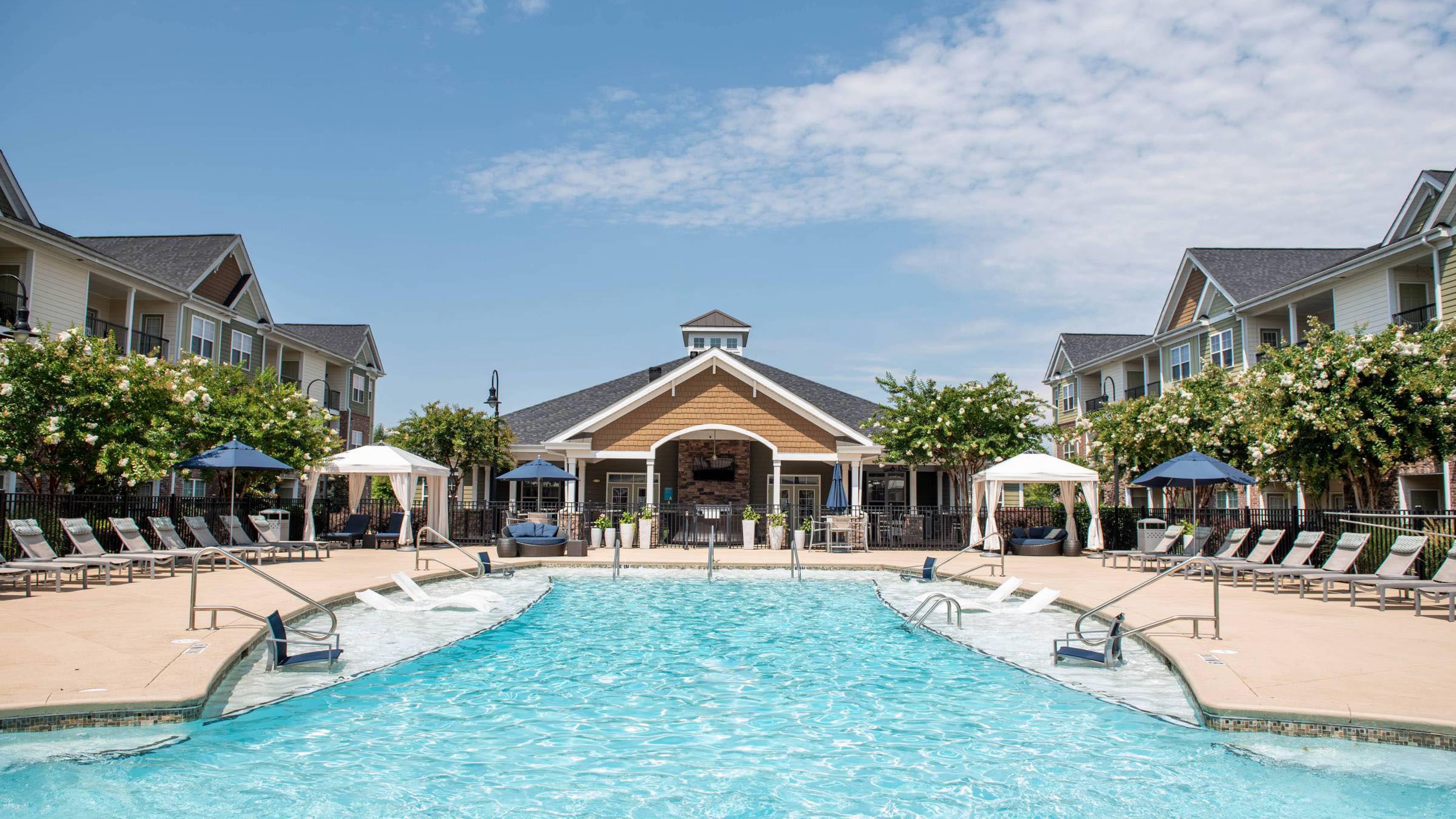 Hawthorne at the Summit luxury outdoor pool with in-pool lounge chairs and surrounding seating