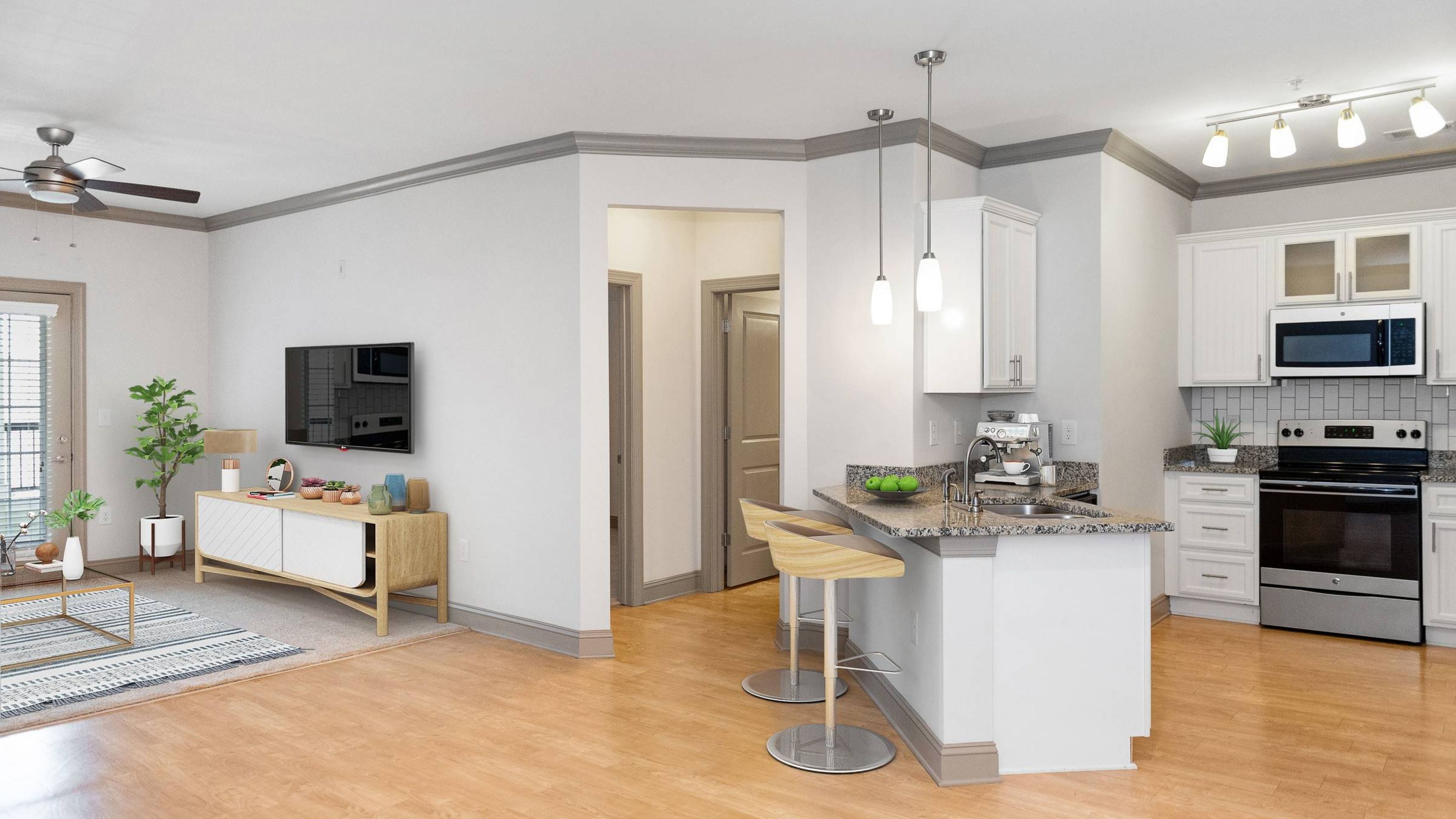 Hawthorne at the Summit modern apartment living space and kitchen with kitchen island, granite countertops, stainless steel appliances, 9ft ceilings